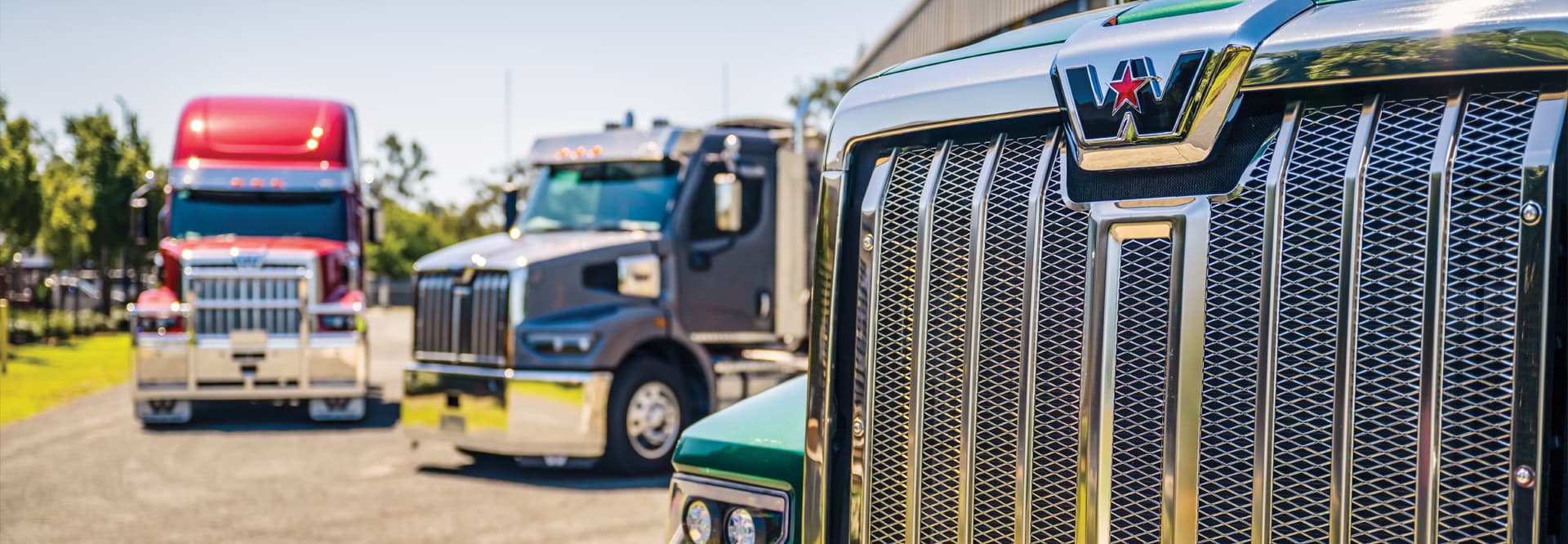 closeup of truck with two more in background